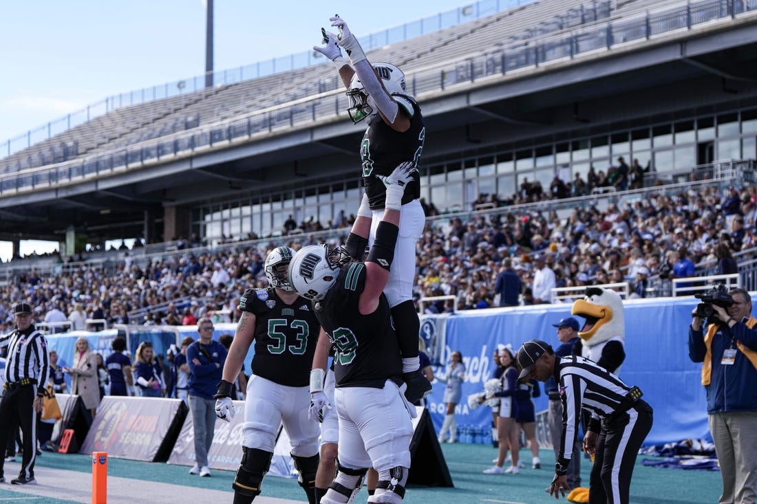 Dec 16, 2023; Conway, SC, USA; Ohio Bobcats running back Rickey Hunt (28) is lifted into the air by Ohio Bobcats offensive lineman Parker Titsworth (69) after a touchdown in the first half against the Georgia Southern Eagles at Brooks Stadium. Mandatory Credit: David Yeazell-USA TODAY Sports