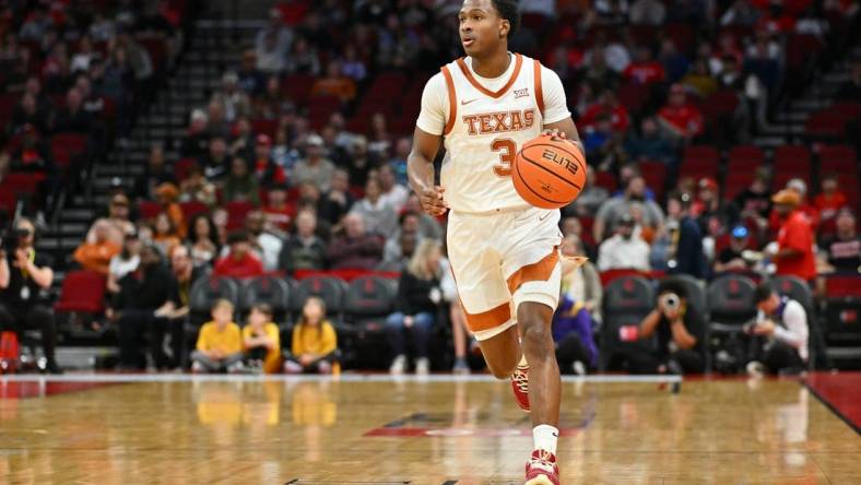 Dec 16, 2023; Houston, Texas, USA; Texas Longhorns guard Max Abmas (3) dribbles the ball against the LSU Tigers during the first half at Toyota Center. Mandatory Credit: Maria Lysaker-USA TODAY Sports