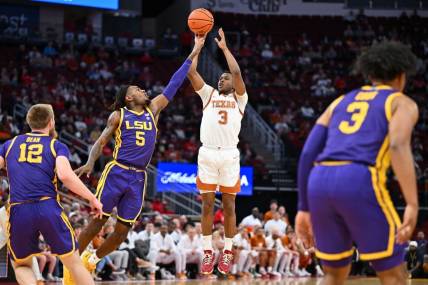 Dec 16, 2023; Houston, Texas, USA; Texas Longhorns guard Max Abmas (3) shoots the ball against LSU Tigers forward Mwani Wilkinson (5) during the first half at Toyota Center. Mandatory Credit: Maria Lysaker-USA TODAY Sports