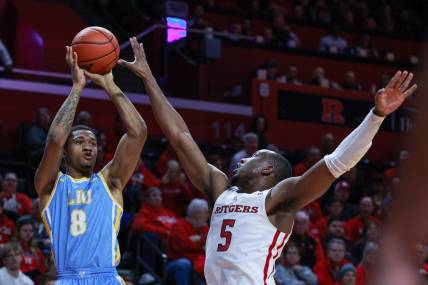 Dec 16, 2023; Piscataway, New Jersey, USA; Long Island Sharks forward Jason Steele (8) shoots the ball as Rutgers Scarlet Knights forward Aundre Hyatt (5) defends during the first half at Jersey Mike's Arena. Mandatory Credit: Vincent Carchietta-USA TODAY Sports