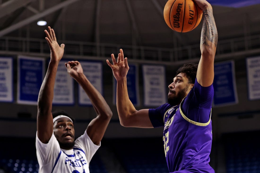 Dec 16, 2023; Hampton, Virginia, USA; James Madison Dukes forward Julien Wooden (22) dunks the ball against Hampton Pirates forward Ja'Von Benson (21) during the first half at Hampton Convocation Center. Mandatory Credit: Peter Casey-USA TODAY Sports