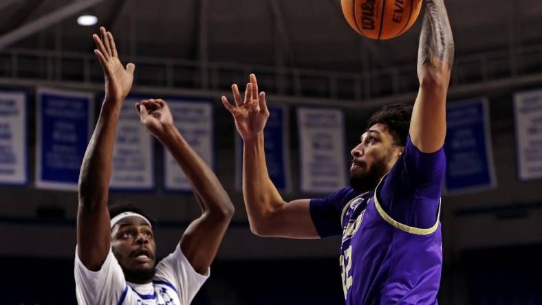 Dec 16, 2023; Hampton, Virginia, USA; James Madison Dukes forward Julien Wooden (22) dunks the ball against Hampton Pirates forward Ja'Von Benson (21) during the first half at Hampton Convocation Center. Mandatory Credit: Peter Casey-USA TODAY Sports