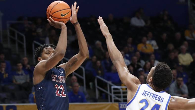 Dec 16, 2023; Pittsburgh, Pennsylvania, USA;  South Carolina State Bulldogs guard James Marrow (22) shoots against Pittsburgh Panthers forward William Jeffress (24) during the first half at Petersen Events Center. Mandatory Credit: Charles LeClaire-USA TODAY Sports