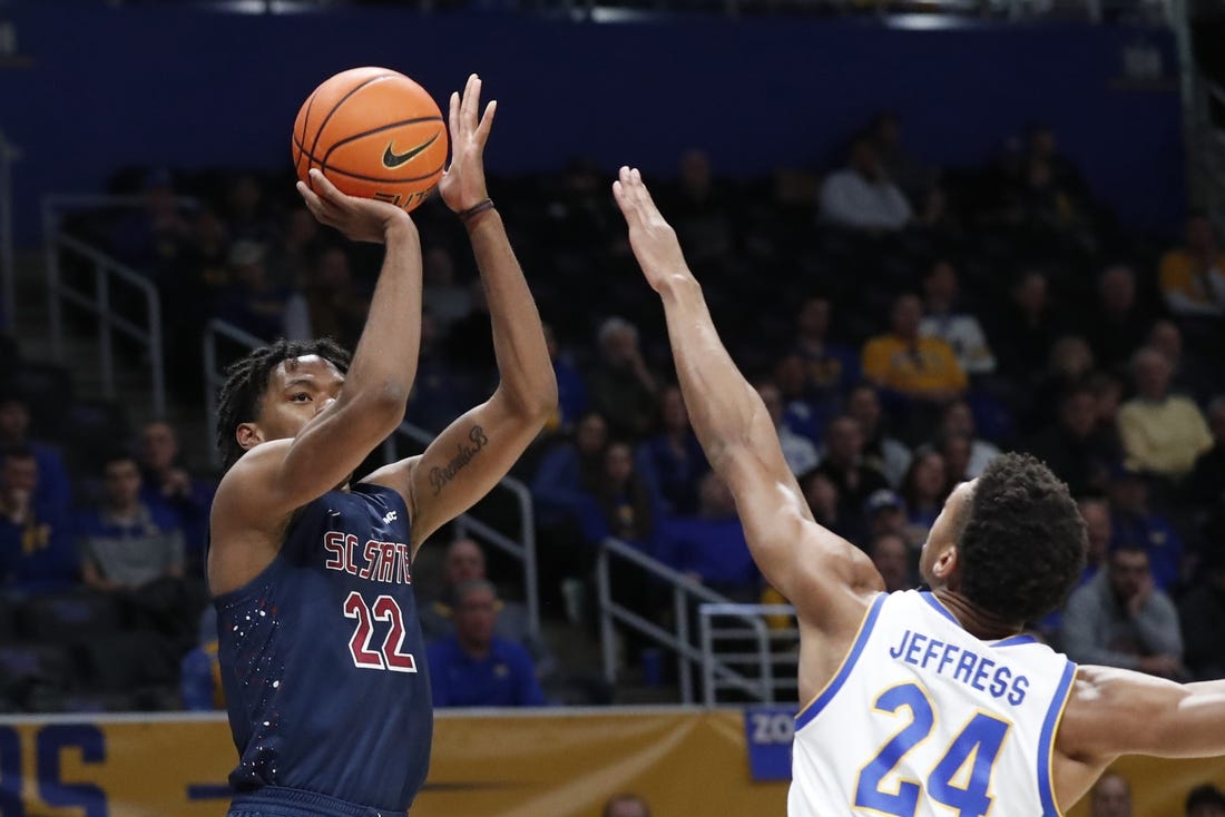Dec 16, 2023; Pittsburgh, Pennsylvania, USA;  South Carolina State Bulldogs guard James Marrow (22) shoots against Pittsburgh Panthers forward William Jeffress (24) during the first half at Petersen Events Center. Mandatory Credit: Charles LeClaire-USA TODAY Sports
