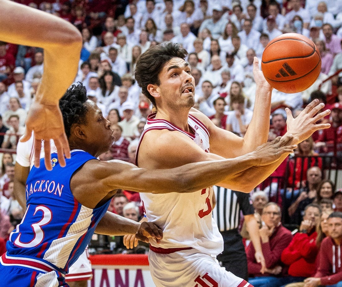 Indiana's Trey Galloway (32) is fouled by Kansas' Elmarko Jackson (13) during the first half of the Indiana versus Kansas men's basketball game at Simon Skjodt Assembly Hall on Saturday, Dec. 16, 2023.