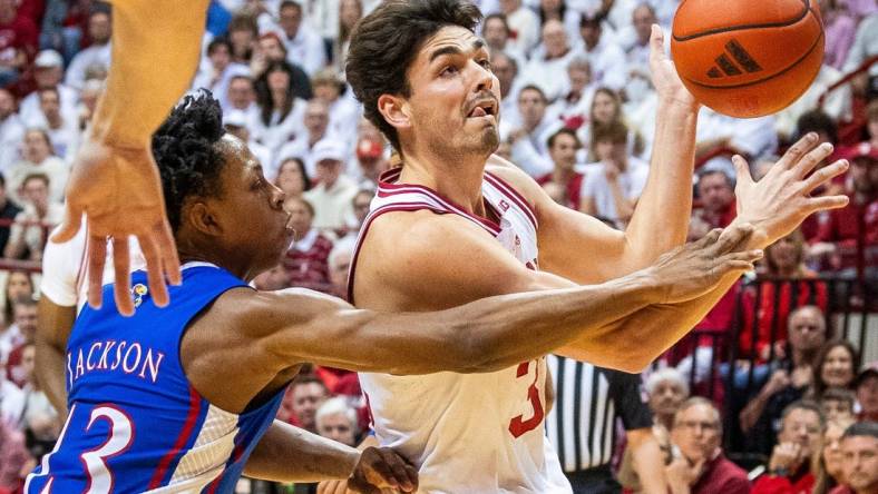 Indiana's Trey Galloway (32) is fouled by Kansas' Elmarko Jackson (13) during the first half of the Indiana versus Kansas men's basketball game at Simon Skjodt Assembly Hall on Saturday, Dec. 16, 2023.