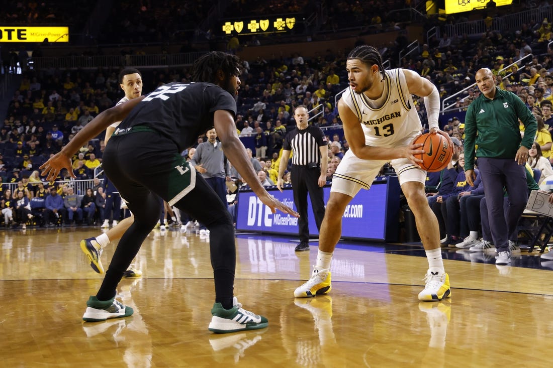 Dec 16, 2023; Ann Arbor, Michigan, USA; Michigan Wolverines forward Olivier Nkamhoua (13) is defended by Eastern Michigan Eagles forward Yusuf Jihad (22) in the first half at Crisler Center. Mandatory Credit: Rick Osentoski-USA TODAY Sports