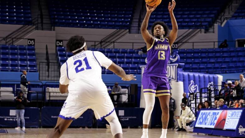 Dec 16, 2023; Hampton, Virginia, USA; James Madison Dukes guard Michael Green III (13) shoots the ball against Hampton Pirates forward Ja'Von Benson (21) during the second half at Hampton Convocation Center. Mandatory Credit: Peter Casey-USA TODAY Sports