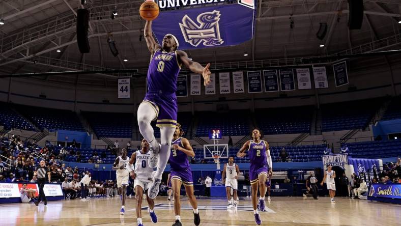 Dec 16, 2023; Hampton, Virginia, USA; James Madison Dukes guard Xavier Brown (0) dunks the ball against the Hampton Pirates during the second half at Hampton Convocation Center. Mandatory Credit: Peter Casey-USA TODAY Sports