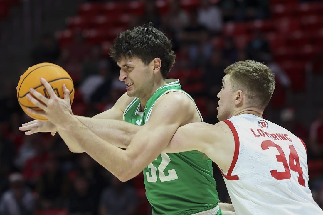 Dec 16, 2023; Salt Lake City, Utah, USA; Utah Valley Wolverines center Trevin Dorius (32) has the ball knocked away by Utah Utes center Lawson Lovering (34) during the first half at Jon M. Huntsman Center. Mandatory Credit: Rob Gray-USA TODAY Sports