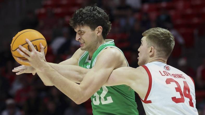 Dec 16, 2023; Salt Lake City, Utah, USA; Utah Valley Wolverines center Trevin Dorius (32) has the ball knocked away by Utah Utes center Lawson Lovering (34) during the first half at Jon M. Huntsman Center. Mandatory Credit: Rob Gray-USA TODAY Sports