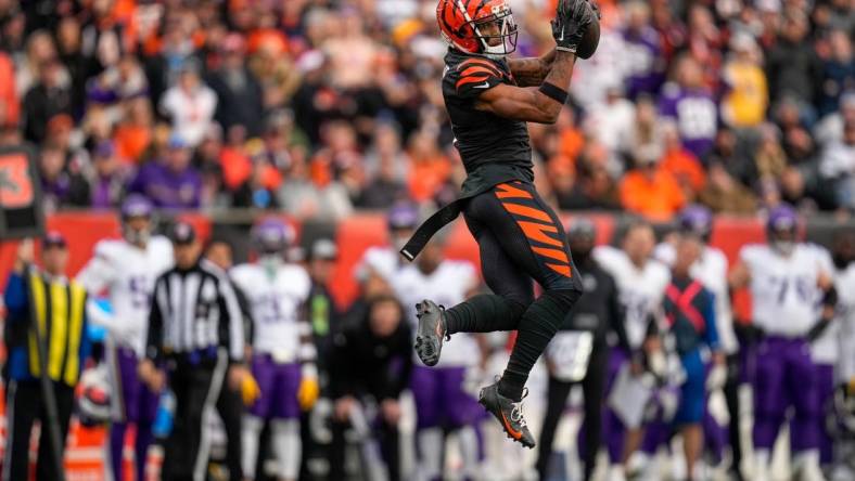 Cincinnati Bengals wide receiver Ja'Marr Chase (1) makes a leaping catch in the fourth quarter of the NFL Week 15 game between the Cincinnati Bengals and the Minnesota Vikings at PayCor Stadium in downtown Cincinnati on Saturday, Dec. 16, 2023. The Bengals won on an overtime field goal.