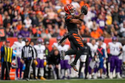 Cincinnati Bengals wide receiver Ja'Marr Chase (1) makes a leaping catch in the fourth quarter of the NFL Week 15 game between the Cincinnati Bengals and the Minnesota Vikings at PayCor Stadium in downtown Cincinnati on Saturday, Dec. 16, 2023. The Bengals won on an overtime field goal.