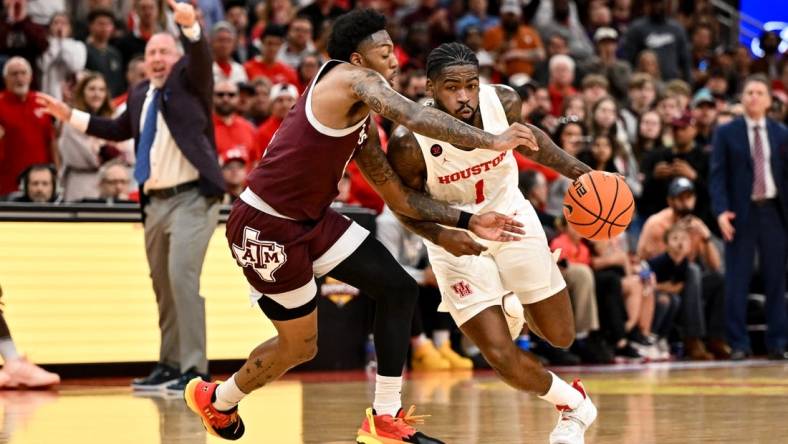 Dec 16, 2023; Houston, Texas, USA; Houston Cougars guard Jamal Shead (1) drives to the basket as Texas A&M Aggies guard Wade Taylor IV (4) defends during the second half at Toyota Center. Mandatory Credit: Maria Lysaker-USA TODAY Sports