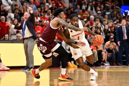 Dec 16, 2023; Houston, Texas, USA; Houston Cougars guard Jamal Shead (1) drives to the basket as Texas A&M Aggies guard Wade Taylor IV (4) defends during the second half at Toyota Center. Mandatory Credit: Maria Lysaker-USA TODAY Sports