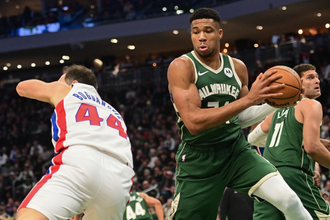 Dec 16, 2023; Milwaukee, Wisconsin, USA; Milwaukee Bucks forward Giannis Antetokounmpo (34) grabs a rebound against Detroit Pistons forward Bojan Bogdanovic (44) in the first quarter at Fiserv Forum. Mandatory Credit: Benny Sieu-USA TODAY Sports