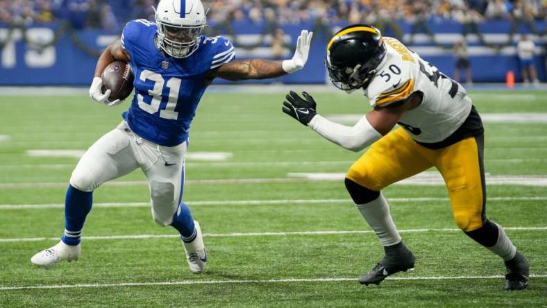 Indianapolis Colts running back Tyler Goodson (31) reaches to stiff arm Pittsburgh Steelers linebacker Elandon Roberts (50) as he rushes toward the end zone Saturday, Dec. 16, 2023, during a game against the Pittsburgh Steelers at Lucas Oil Stadium in Indianapolis.