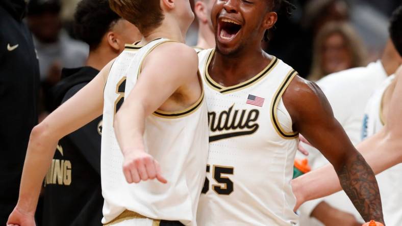 Purdue Boilermakers guard Fletcher Loyer (2) and Purdue Boilermakers guard Lance Jones (55) celebrate during a timeout during the NCAA men   s basketball game against the Arizona Wildcats, Saturday, Dec. 16, 2023, at Gainbridge Fieldhouse in Indianapolis. Purdue Boilermakers won 92-84.