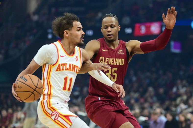 Dec 16, 2023; Cleveland, Ohio, USA; Atlanta Hawks guard Trae Young (11) drives to the basket against Cleveland Cavaliers forward Isaac Okoro (35) during the first quarter at Rocket Mortgage FieldHouse. Mandatory Credit: Ken Blaze-USA TODAY Sports