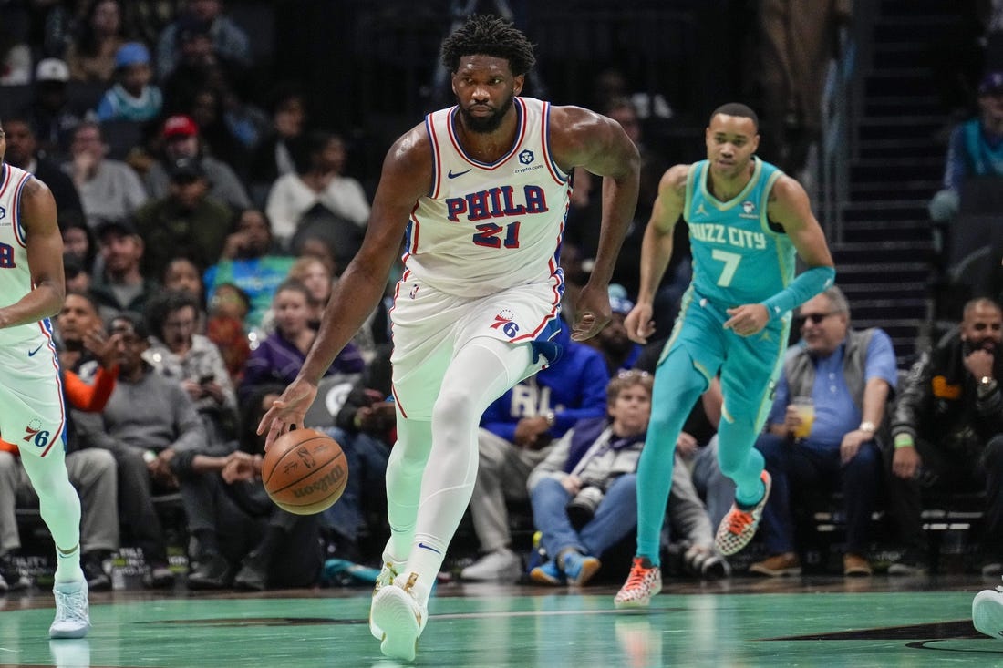 Dec 16, 2023; Charlotte, North Carolina, USA;Philadelphia 76ers center Joel Embiid (21) handles the ball against the Charlotte Hornets during the first quarter at Spectrum Center. Mandatory Credit: Jim Dedmon-USA TODAY Sports