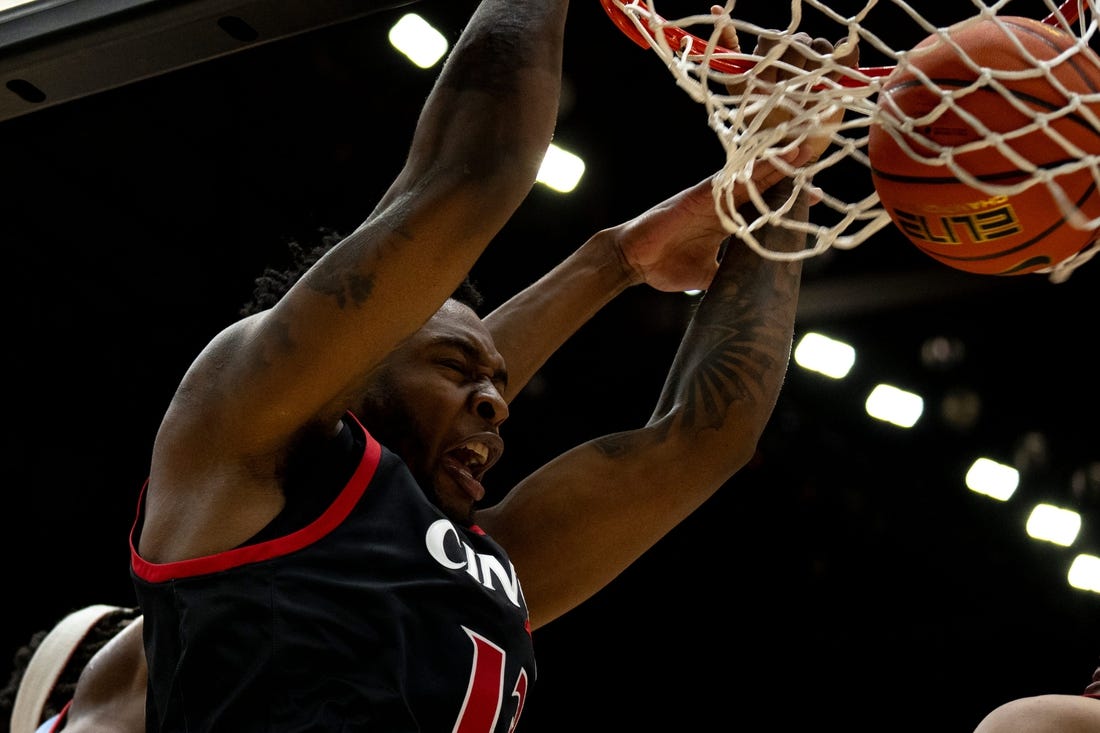 Cincinnati Bearcats forward Jamille Reynolds (13) dunks around Dayton Flyers forward DaRon holmes II (15) in the first half of the NCAA men's basketball game between the Dayton Flyers and Cincinnati Bearcats at Heritage Bank Center in Cincinnati on Saturday, Dec. 16, 2023.