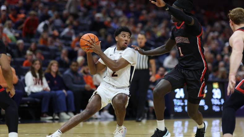 Dec 16, 2023; Charlottesville, Virginia, USA; Virginia Cavaliers guard Reece Beekman (2) holds the ball as Northeastern Huskies guard Masai Troutman (1) defends in the second half at John Paul Jones Arena. Mandatory Credit: Geoff Burke-USA TODAY Sports