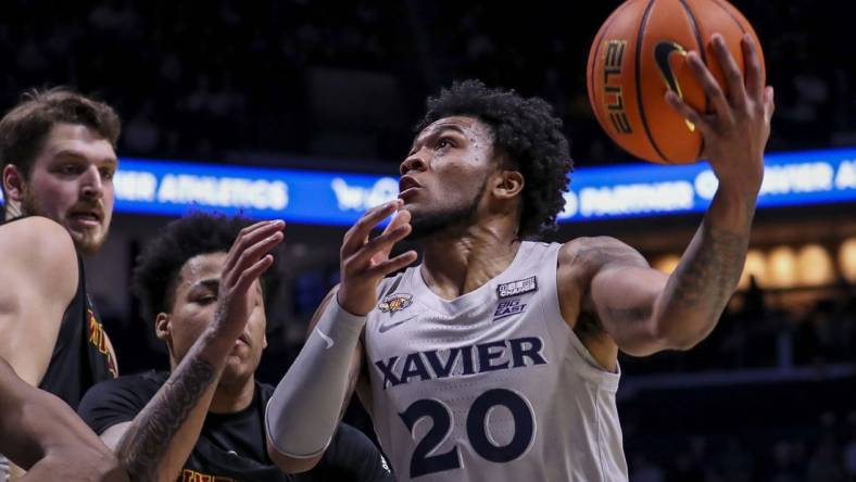 Dec 16, 2023; Cincinnati, Ohio, USA; Xavier Musketeers guard Dayvion McKnight (20) drives to the basket against the Winthrop Eagles in the first half at Cintas Center. Mandatory Credit: Katie Stratman-USA TODAY Sports