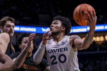 Dec 16, 2023; Cincinnati, Ohio, USA; Xavier Musketeers guard Dayvion McKnight (20) drives to the basket against the Winthrop Eagles in the first half at Cintas Center. Mandatory Credit: Katie Stratman-USA TODAY Sports