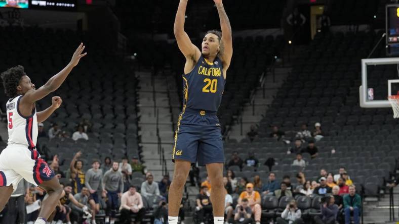 Dec 16, 2023; San Antonio, Texas, USA; California Golden Bears guard Jaylon Tyson (20) shoots in front of Mississippi Rebels guard Jaylen Murray (5) in the first half at the Frost Bank Center. Mandatory Credit: Daniel Dunn-USA TODAY Sports