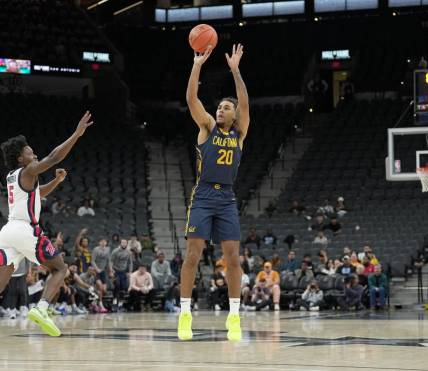 Dec 16, 2023; San Antonio, Texas, USA; California Golden Bears guard Jaylon Tyson (20) shoots in front of Mississippi Rebels guard Jaylen Murray (5) in the first half at the Frost Bank Center. Mandatory Credit: Daniel Dunn-USA TODAY Sports