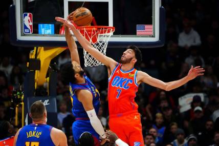 Dec 16, 2023; Denver, Colorado, USA; Denver Nuggets guard Jamal Murray (27) scores against Oklahoma City Thunder forward Chet Holmgren (7) in the first quarter at Ball Arena. Mandatory Credit: Ron Chenoy-USA TODAY Sports
