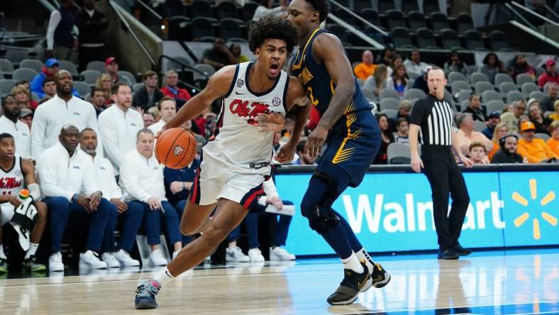 Dec 16, 2023; San Antonio, Texas, USA; Mississippi Rebels forward Jaemyn Brakefield (4) dribbles against California Golden Bears guard Jalen Celestine (32) in the second half at the Frost Bank Center. Mandatory Credit: Daniel Dunn-USA TODAY Sports