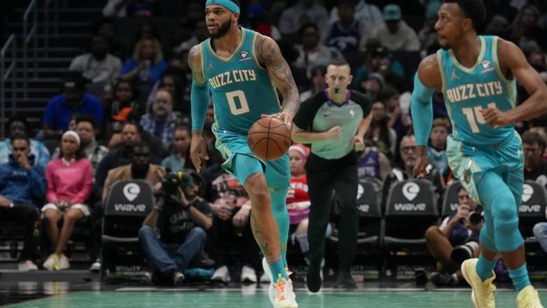 Dec 16, 2023; Charlotte, North Carolina, USA; Charlotte Hornets forward Miles Bridges (0) brings the ball up court against the Philadelphia 76ers during the second half at Spectrum Center. Mandatory Credit: Jim Dedmon-USA TODAY Sports