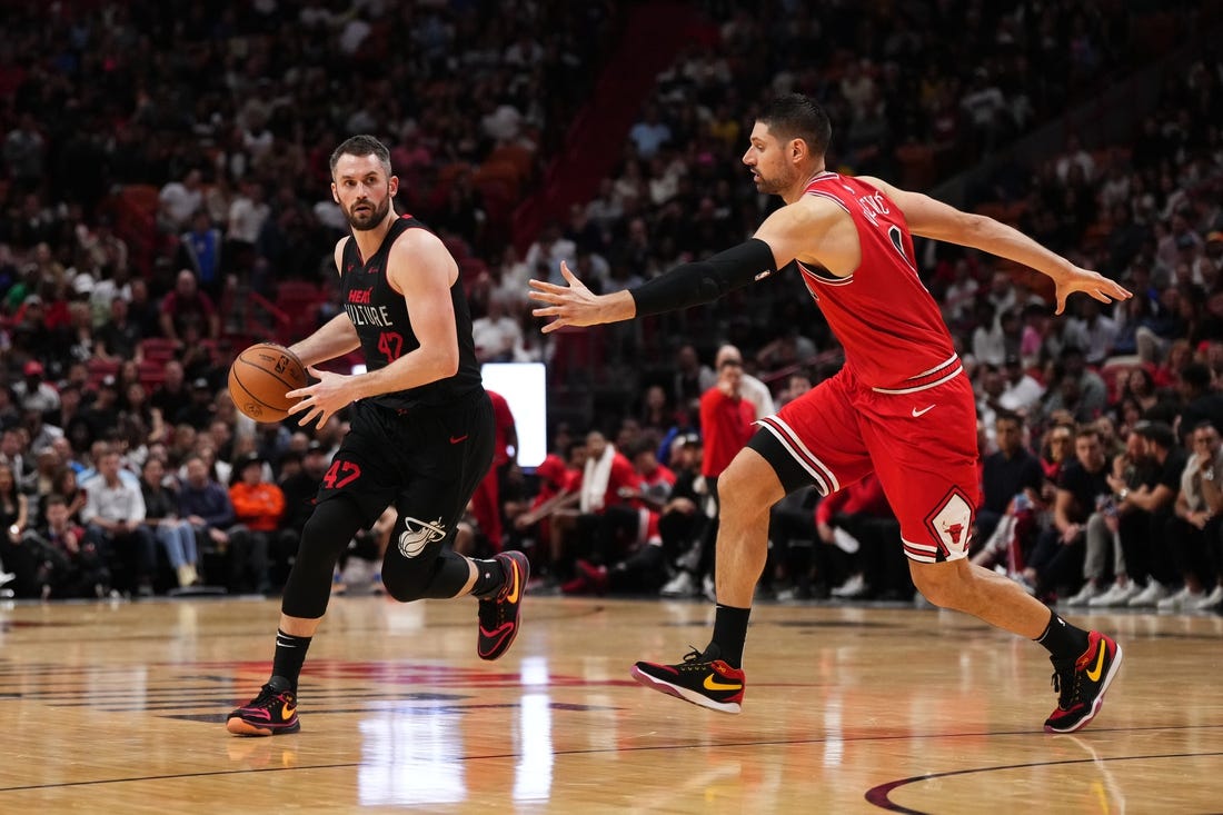 Dec 16, 2023; Miami, Florida, USA; Miami Heat forward Kevin Love (42) dribbles the ball around Miami Heat guard Dru Smith (9) during the second half at Kaseya Center. Mandatory Credit: Jasen Vinlove-USA TODAY Sports