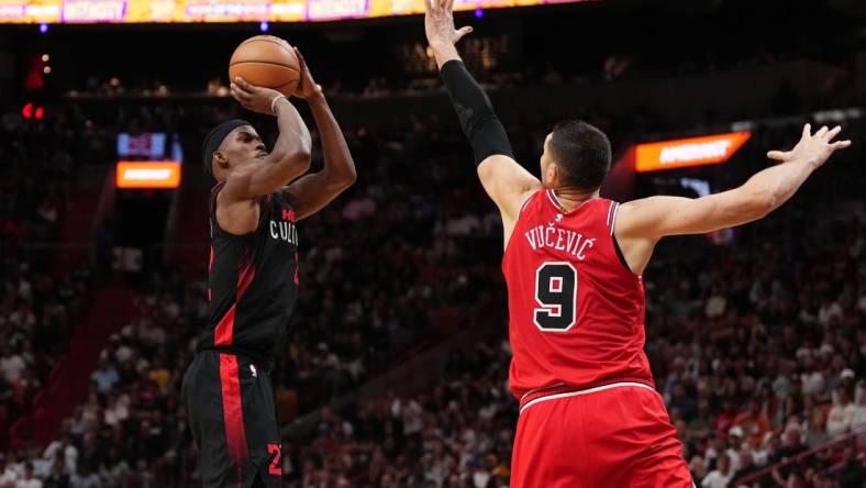 Dec 16, 2023; Miami, Florida, USA; Miami Heat forward Jimmy Butler (22) shoots over Chicago Bulls center Nikola Vucevic (9) during the second half at Kaseya Center. Mandatory Credit: Jasen Vinlove-USA TODAY Sports