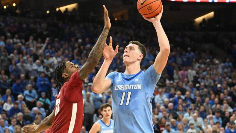 Dec 16, 2023; Omaha, Nebraska, USA; Creighton Bluejays center Ryan Kalkbrenner (11) attempts a shot against Alabama Crimson Tide forward Nick Pringle (23) in the second half at CHI Health Center Omaha. Mandatory Credit: Steven Branscombe-USA TODAY Sports