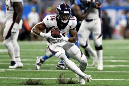 Dec 16, 2023; Detroit, Michigan, USA; Denver Broncos wide receiver Courtland Sutton (14) runs with the ball against the Detroit Lions in the third quarter at Ford Field. Mandatory Credit: Lon Horwedel-USA TODAY Sports