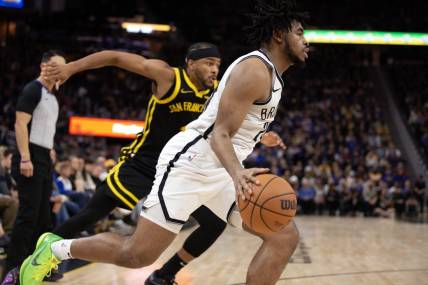 Dec 16, 2023; San Francisco, California, USA; Brooklyn Nets guard Cam Thomas (24) drives the baseline ahead of Golden State Warriors guard Moses Moody (4) during the third quarter at Chase Center. Mandatory Credit: D. Ross Cameron-USA TODAY Sports