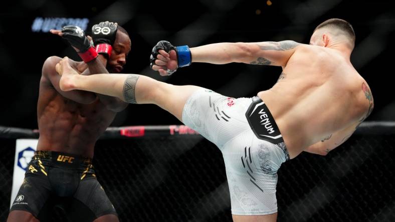 Dec 16, 2023; Las Vegas, Nevada, USA; Leon Edwards (red gloves) fights Colby Covington (blue gloves) during UFC 296 at T-Mobile Arena. Mandatory Credit: Stephen R. Sylvanie-USA TODAY Sports