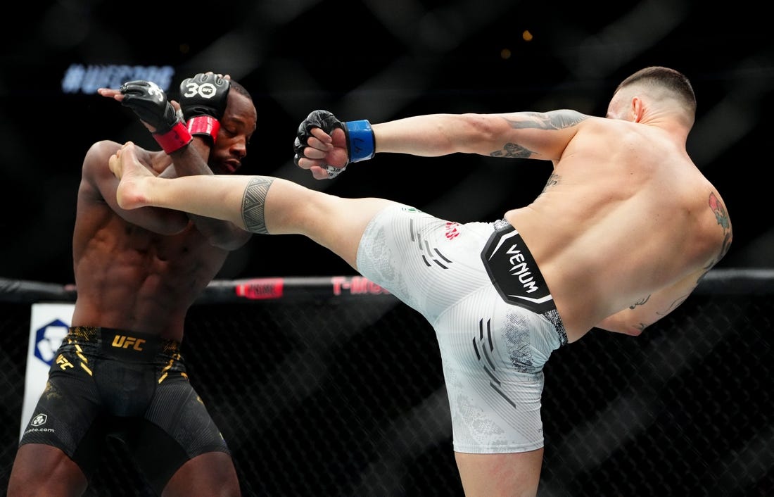 Dec 16, 2023; Las Vegas, Nevada, USA; Leon Edwards (red gloves) fights Colby Covington (blue gloves) during UFC 296 at T-Mobile Arena. Mandatory Credit: Stephen R. Sylvanie-USA TODAY Sports