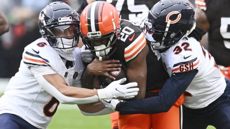 Dec 17, 2023; Cleveland, Ohio, USA; Chicago Bears cornerback Kyler Gordon (6) and cornerback Terell Smith (32) tackle Cleveland Browns running back Pierre Strong Jr. (20) during the first quarter at Cleveland Browns Stadium. Mandatory Credit: Ken Blaze-USA TODAY Sports