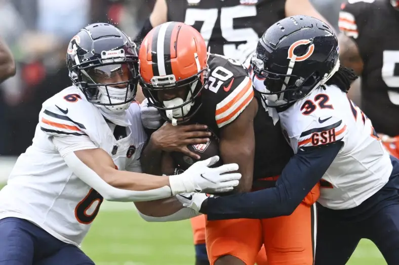 Dec 17, 2023; Cleveland, Ohio, USA; Chicago Bears cornerback Kyler Gordon (6) and cornerback Terell Smith (32) tackle Cleveland Browns running back Pierre Strong Jr. (20) during the first quarter at Cleveland Browns Stadium. Mandatory Credit: Ken Blaze-USA TODAY Sports