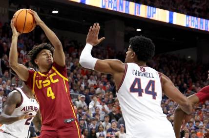 Dec 17, 2023; Auburn, Alabama, USA;  USC Trojans guard Oziyah Sellers (4) looks for a pass as Auburn Tigers center Dylan Cardwell (44) defends during the first half at Neville Arena. Mandatory Credit: John Reed-USA TODAY Sports