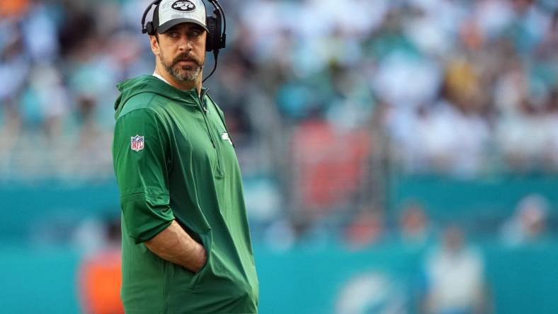 Dec 17, 2023; Miami Gardens, Florida, USA; New York Jets quarterback Aaron Rodgers (8) walks onto the field during an injury timeout in the first half against the Miami Dolphins at Hard Rock Stadium. Mandatory Credit: Jasen Vinlove-USA TODAY Sports