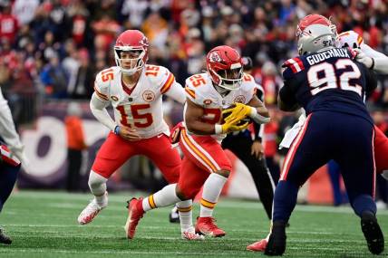 Dec 17, 2023; Foxborough, Massachusetts, USA; Kansas City Chiefs quarterback Patrick Mahomes (15) hands the ball off to running back Clyde Edwards-Helaire (25) during the first half against the New England Patriots at Gillette Stadium. Mandatory Credit: Eric Canha-USA TODAY Sports