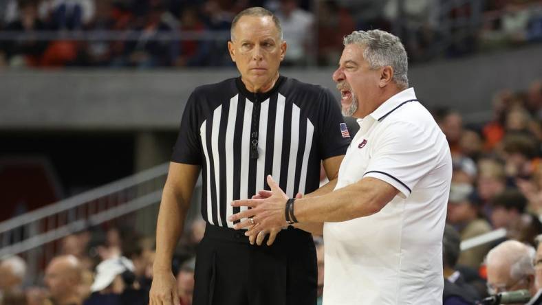 Dec 17, 2023; Auburn, Alabama, USA;  Auburn Tigers head coach Bruce Pearl talks to a game official during the second half against the USC Trojans at Neville Arena. Mandatory Credit: John Reed-USA TODAY Sports