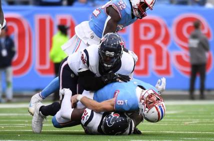 Dec 17, 2023; Nashville, Tennessee, USA; Tennessee Titans quarterback Will Levis (8) is injured after being sacked by Houston Texans cornerback Desmond King II (25) defensive tackle Sheldon Rankins (98) in overtime at Nissan Stadium. Mandatory Credit: Christopher Hanewinckel-USA TODAY Sports