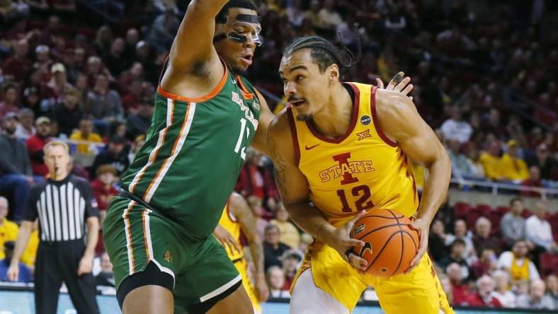 Iowa State Cyclones forward Robert Jones (12) drives to the basket around Florida A&M Rattlers forward Shannon Grant (13) during the first half of a NCAA college basketball at Hilton Coliseum on Sunday, Dec. 17, 2023, in Ames, Iowa.