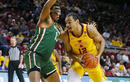 Iowa State Cyclones forward Robert Jones (12) drives to the basket around Florida A&M Rattlers forward Shannon Grant (13) during the first half of a NCAA college basketball at Hilton Coliseum on Sunday, Dec. 17, 2023, in Ames, Iowa.