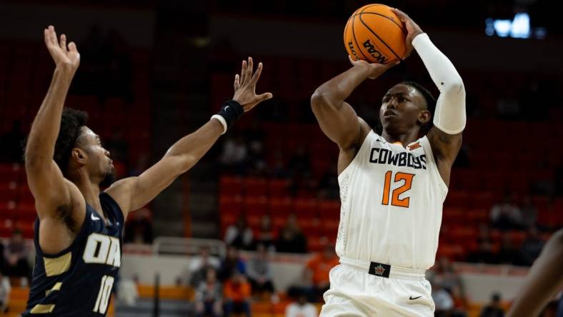 Dec 17, 2023; Stillwater, Okla, USA ; Oklahoma State Cowboys guard Javon Small (12) shoots over Oral Roberts Golden Eagles guard Issac McBride (10) in the first half of an NCAA basketball game at Gallagher Iba arena. Mandatory Credit: Mitch Alcala-The Oklahoman